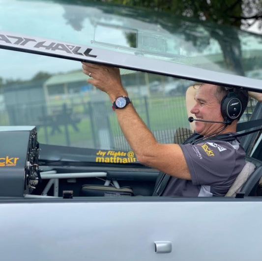 Stunt RAAF pilot Matt Hall in aircrafy cockpit wearing RAAF Air Force 2021 centenary Aviator anti-magnetic watch
